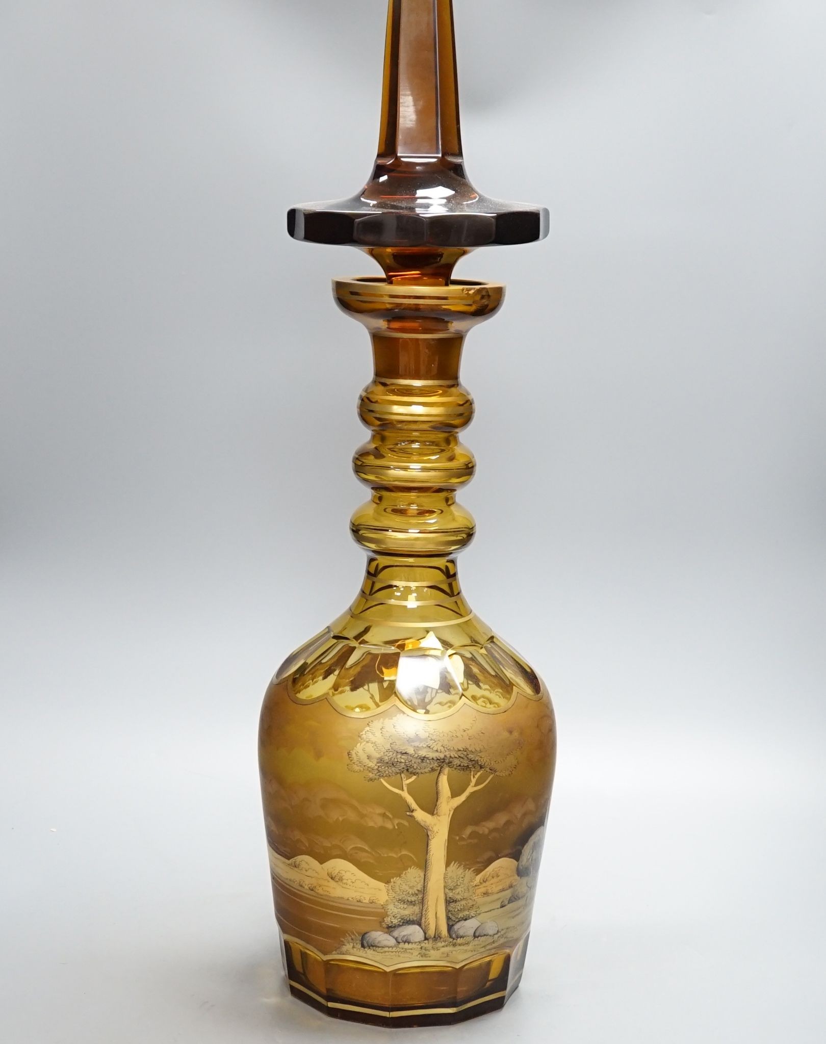 A large amber glass decanter and stopper, 74cm